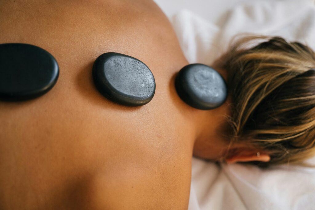 Peaceful spa setting with hot stone therapy promoting relaxation and relief.